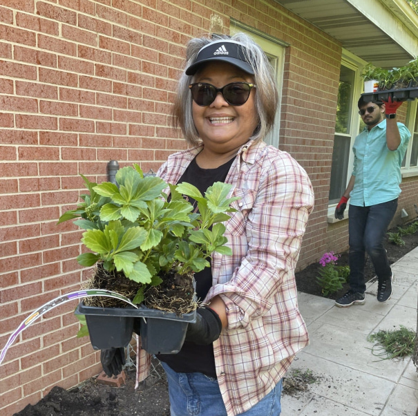 a woman holding a plant
