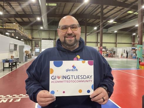 a man holding a sign in a gym