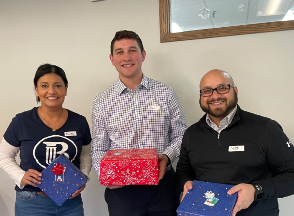 a group of people holding presents